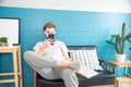 Handsome caucasian man sitting on sofa and play on cell phone ,surf the social media ,in the living room on morning time.Relax and Royalty Free Stock Photo