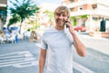 Handsome caucasian man smiling happy outdoors speaking on the phone Royalty Free Stock Photo