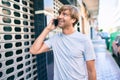 Handsome caucasian man smiling happy outdoors speaking on the phone Royalty Free Stock Photo