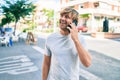 Handsome caucasian man smiling happy outdoors speaking on the phone Royalty Free Stock Photo