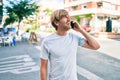 Handsome caucasian man smiling happy outdoors speaking on the phone Royalty Free Stock Photo