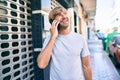 Handsome caucasian man smiling happy outdoors speaking on the phone Royalty Free Stock Photo