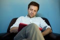 Handsome caucasian man using his tablet sitting on a couch Royalty Free Stock Photo