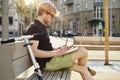 Handsome caucasian man using laptop sitting outdoor in a park. Summer sunshine day. Concept of young business people working Royalty Free Stock Photo