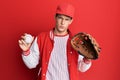 Handsome caucasian man wearing baseball uniform holding golve and ball depressed and worry for distress, crying angry and afraid Royalty Free Stock Photo