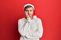 Handsome caucasian man wearing christmas hat thinking looking tired and bored with depression problems with crossed arms Royalty Free Stock Photo