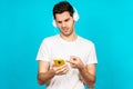 Handsome Caucasian man wearing headphones and listening to music - not liking it at all Royalty Free Stock Photo