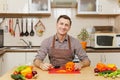 Handsome caucasian young man, sitting at table. Healthy lifestyle. Cooking at home. Prepare food. Royalty Free Stock Photo