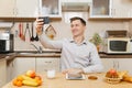 Handsome caucasian young man, sitting at table. Healthy lifestyle. Cooking at home. Prepare food. Royalty Free Stock Photo