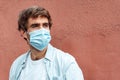 Handsome caucasian young man wearing a mask against coronavirus. New normality portrait