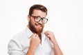 Handsome charming bearded man in eyeglasses and shirt posing