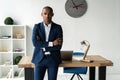 Handsome cheerful african american executive business man at the workspace office. Royalty Free Stock Photo