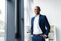 Handsome cheerful african american executive business man at the workspace office. Royalty Free Stock Photo