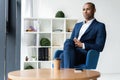 Handsome cheerful african american executive business man at the workspace office. Royalty Free Stock Photo