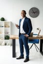 Handsome cheerful african american executive business man at the workspace office. Royalty Free Stock Photo