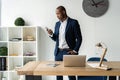 Handsome cheerful african american executive business man at the workspace office. Royalty Free Stock Photo