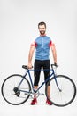 handsome cheerful cyclist in sportswear posing with bike,