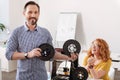 Handsome cheerful man standing with filament coils