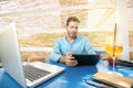 Handsome cheerful young freelance guy working on laptop outside