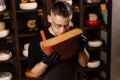 Handsome cheese sommelier holding and sniff limited gouda cheese. Snack tasty piece of cheese for appetizer.