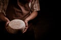 Handsome cheesemaker is checking cheeses in his workshop storage. Royalty Free Stock Photo