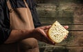 Handsome cheesemaker is checking cheeses in his workshop storage, close up Royalty Free Stock Photo