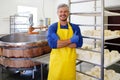 Handsome cheesemaker making curd cheese in his factory. Royalty Free Stock Photo