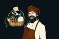 Handsome chef holding a basket of fresh vegetables Royalty Free Stock Photo