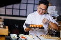 Handsome chef in Japanese restaurant with sushi plate Royalty Free Stock Photo