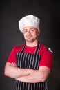 Handsome chef posing against black background Royalty Free Stock Photo