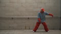 Handsome choreographer practice street dance in gray background. Sprightly.