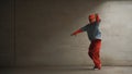 Handsome choreographer practice street dance in gray background. Sprightly.