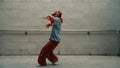 Handsome choreographer practice street dance in gray background. Sprightly.