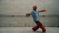 Handsome choreographer practice street dance in gray background. Sprightly.