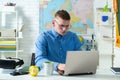 Handsome college boy using notebook. Caucasian male student in university campus works on laptop. Royalty Free Stock Photo