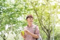 Handsome college student with backpack standing in profile and looking at camera with toothy smile, waist-up portrait Royalty Free Stock Photo