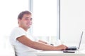 Handsome college student with laptop computer in university library/study room Royalty Free Stock Photo