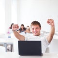 Handsome college student with laptop computer in university library Royalty Free Stock Photo