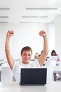 Handsome college student with laptop computer in university library Royalty Free Stock Photo