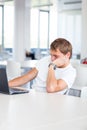 Handsome college student with laptop computer in university library/study room Royalty Free Stock Photo