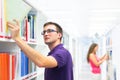 Handsome college student in library Royalty Free Stock Photo