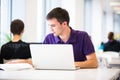 Handsome college student in library Royalty Free Stock Photo