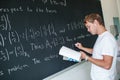 Handsome college student solving a math problem Royalty Free Stock Photo