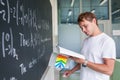 Handsome college student solving a math problem Royalty Free Stock Photo