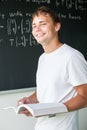 Handsome college student solving a math problem Royalty Free Stock Photo
