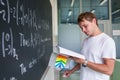 Handsome college student solving a math problem during math class Royalty Free Stock Photo