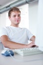 Handsome college student using a computer Royalty Free Stock Photo