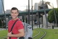 Handsome commuter smiling while waiting for his train Royalty Free Stock Photo