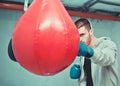 Handsome concentrated male boxer trains hand punches