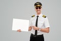 Happy pilot man showing blank white paper